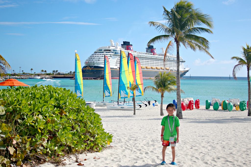 Asian boy on beach at Castaway Cay in the Bahamas