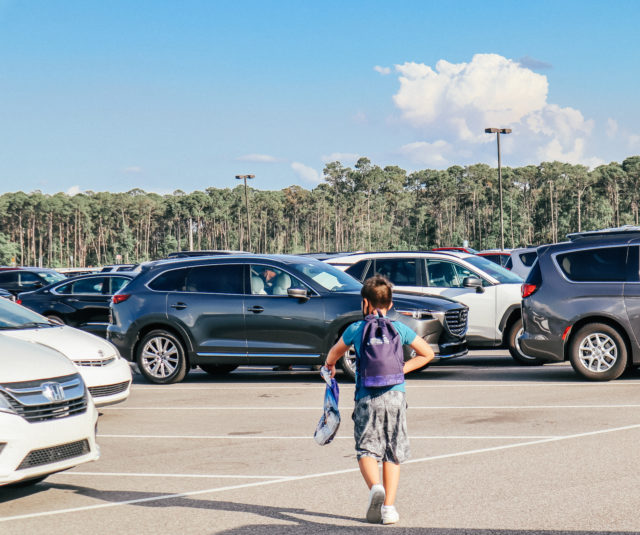 Boy with Droid backpack going to the car after a day at Disney