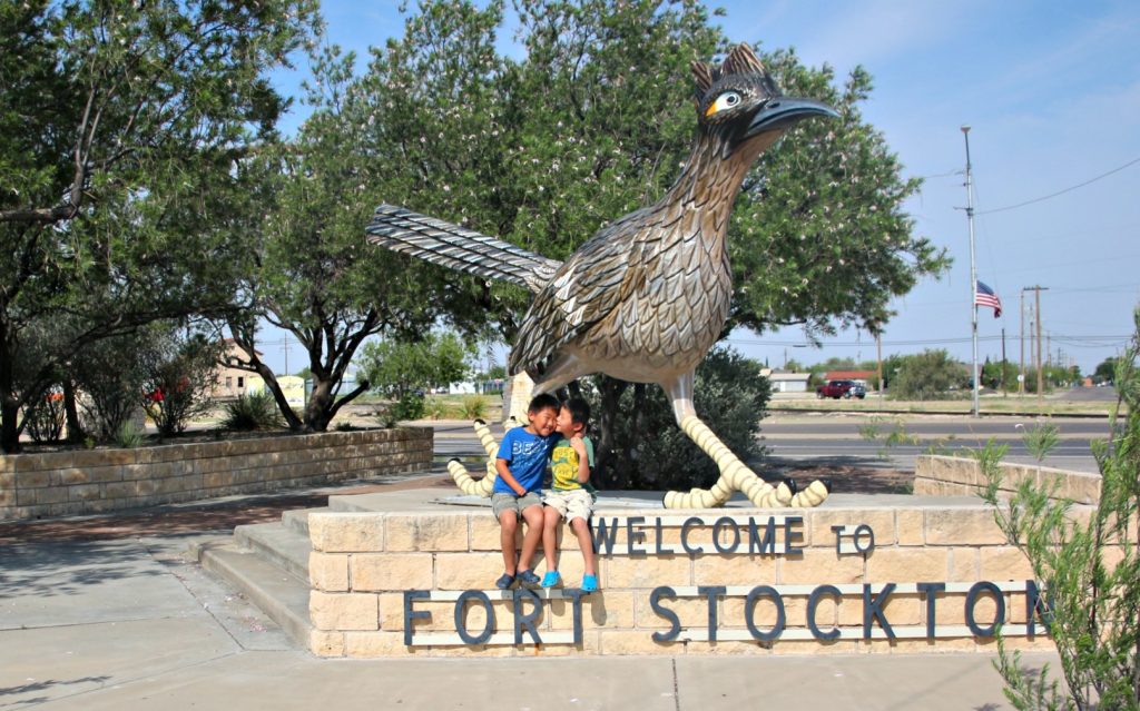 Best Places to stop on a Southwest Road Trip|Two kids in front of giant bird statue in Fort Stockton Texas