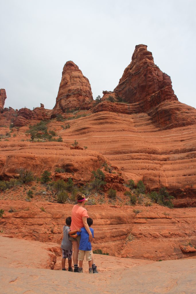 Best Places to stop on a Southwest Road Trip|woman and two boys looking at red rocks in Sedona