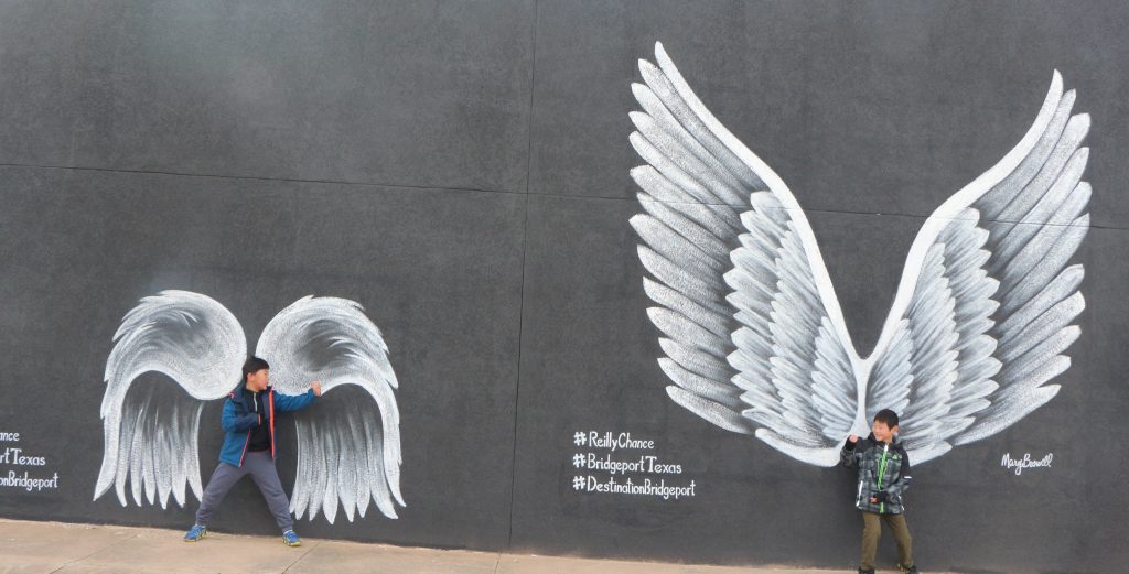 Best places to take Instagram Photos in Decatur Texas|Bridgeport Texas two boys at the angel wing mural