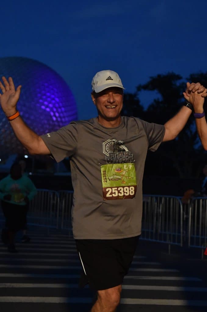 Disney Wine and Dine Half Marathon Weekend - Your Questions Answered|Run Disney Ripped Jeans and Bifocals Man in gray shirt and black shorts running at Epcot