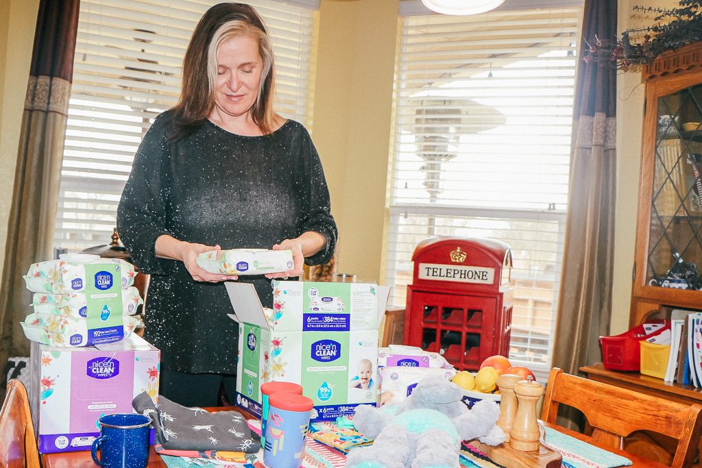 How to get your house ready for a baby...a visiting baby, that is!|Ripped Jeans and Bifocals|Woman looking at baby wipes and baby toys on the table