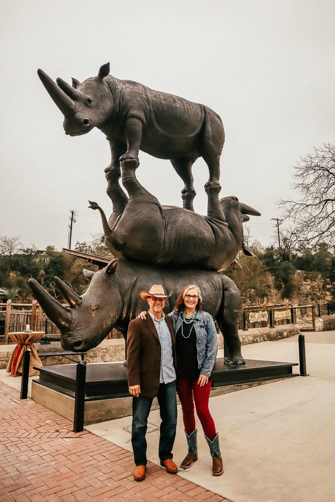 The San Antonio Zoo welcomes two new rhinos|Man and woman in Texas Chic near largest Rhino Sculpture in the World at San Antonio Zoo