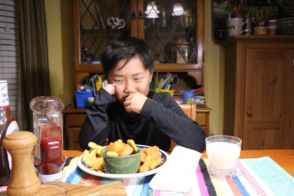 boy eating chicken nuggets