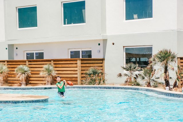 Little boy in pool with football