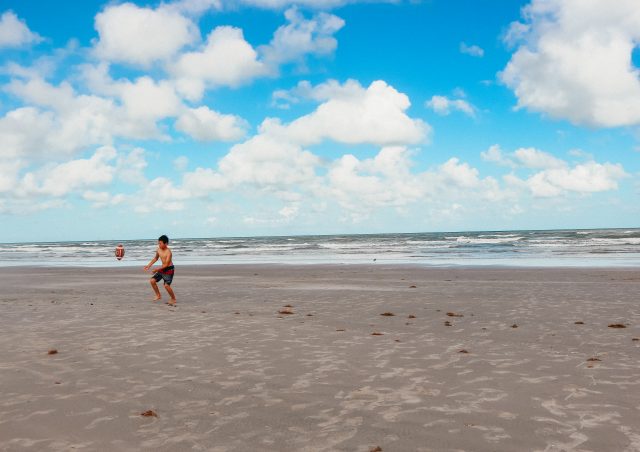 Boy playing ball on beach