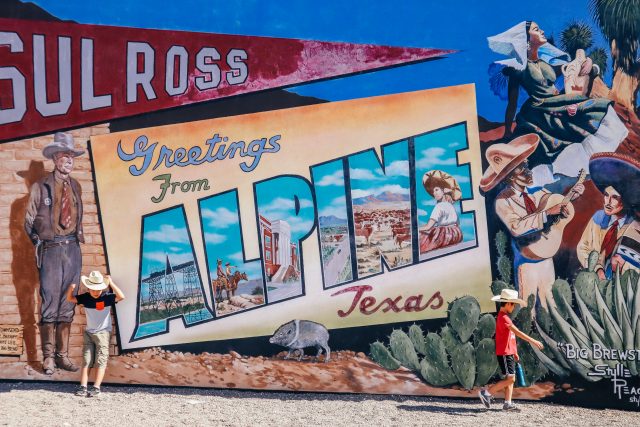 Two boys by Alpine mural in Alpine TX