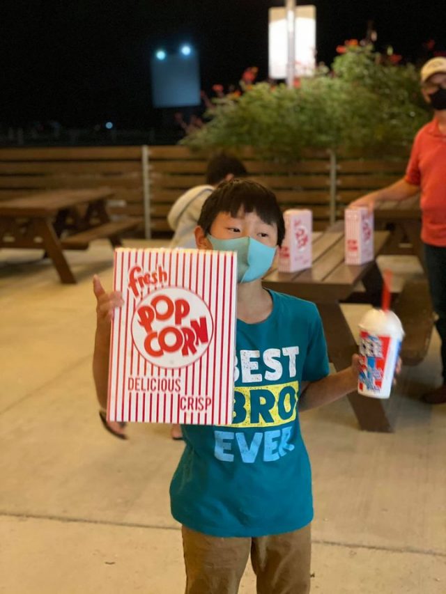 Boy with snack at Stars and Stripes Drive in