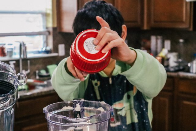 Boy using blender.