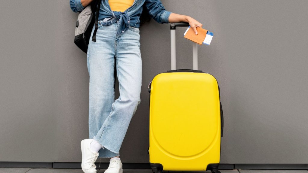 Woman with carry on suitcase.