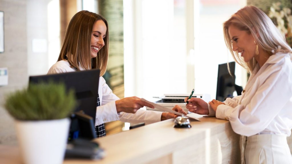 Woman checking in to a hotel.