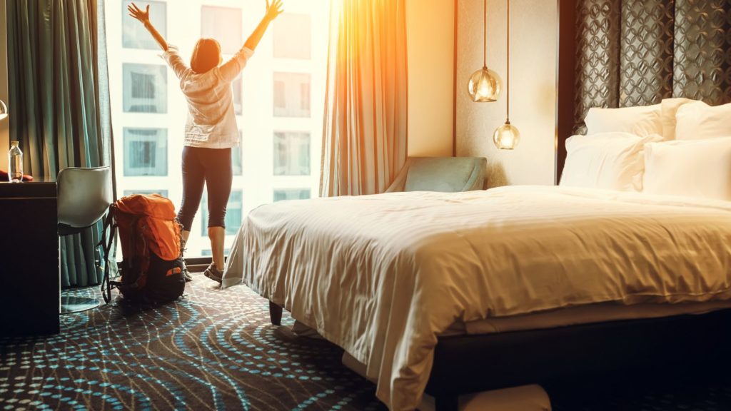 Solo female traveler in a hotel room.