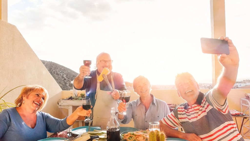 People taking a selfie at a restaurant while traveling.