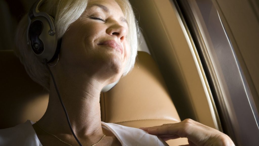 Woman Sleeping On A Plane.