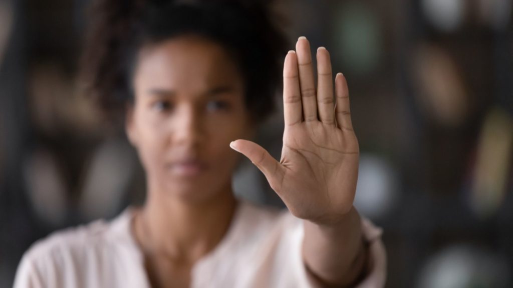 Woman holding up her hand.