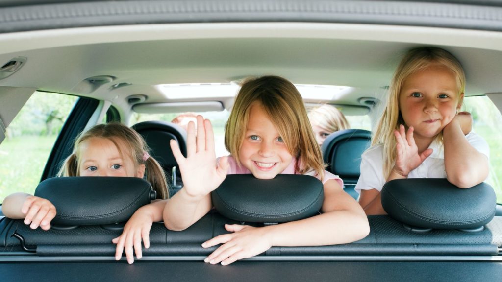 Kids in the back seat of a car.