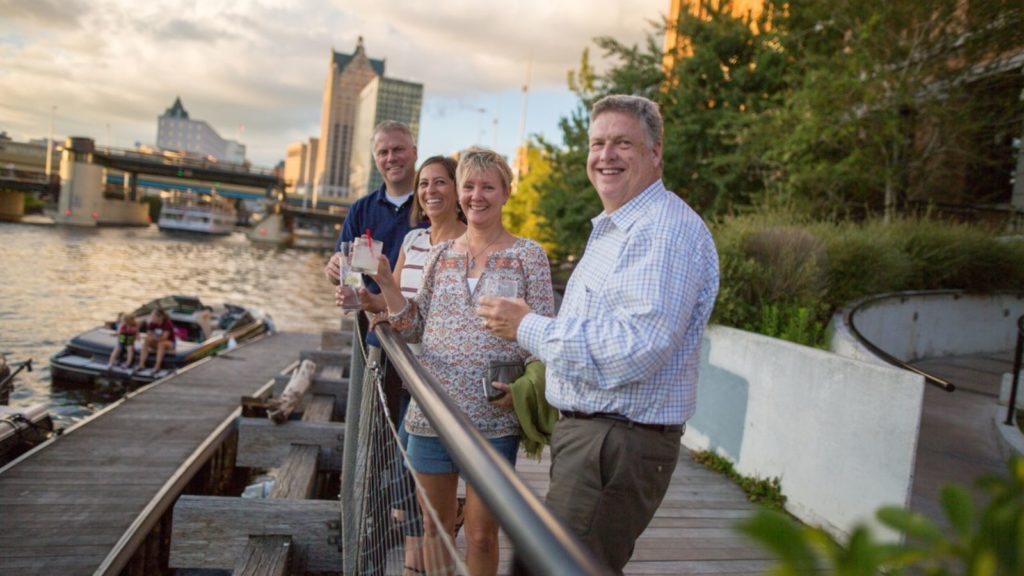 People having drinks by the Milwaukee River.