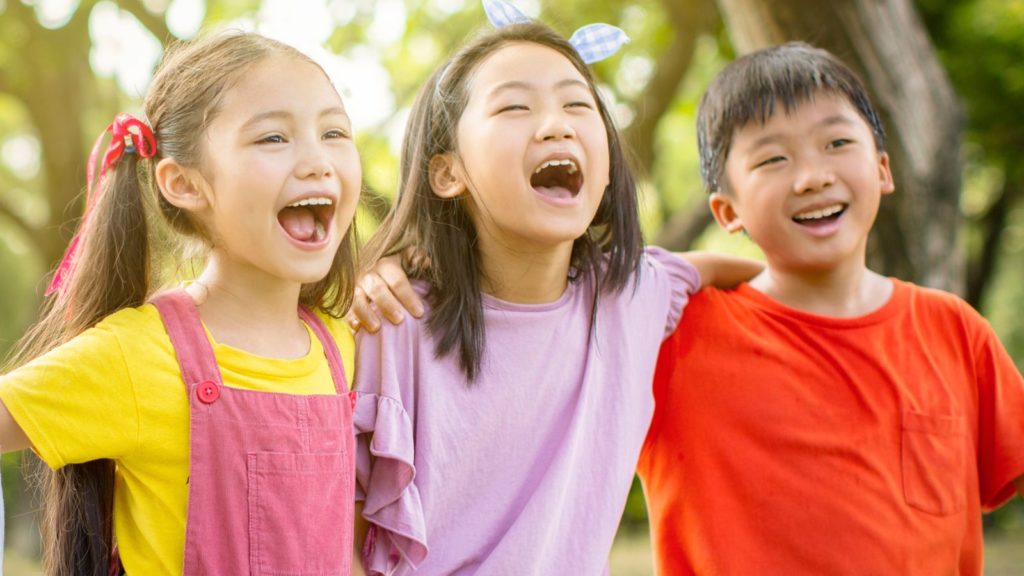 Happy kids wearing bright colors.