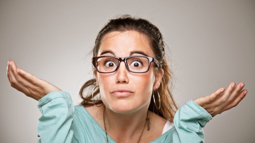 Woman in blue shirt and glasses.