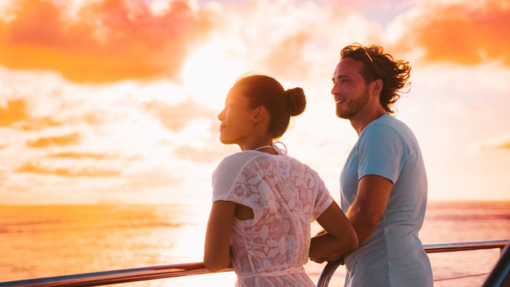 Couple on a cruise ship at sunset.