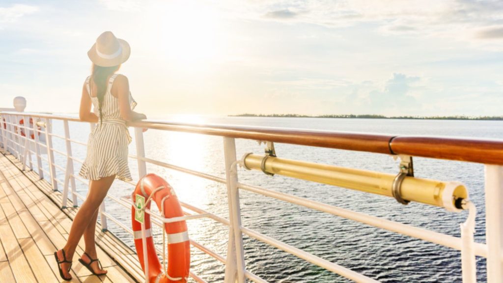 Happy woman on a cruise ship deck.