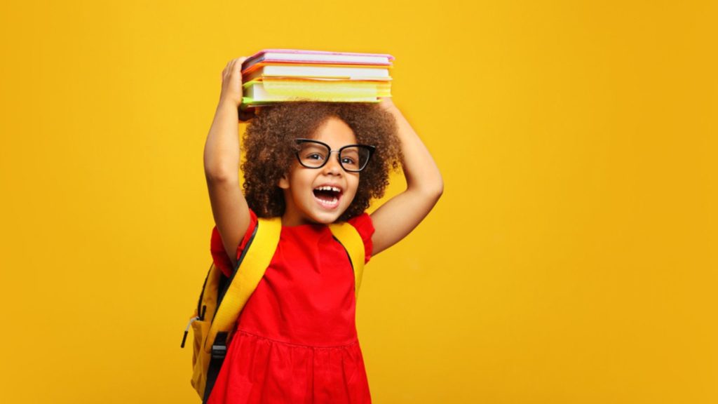 Girl with school books on her head.